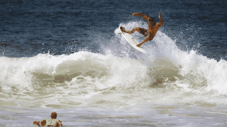 man-surfing-green-wave-surfer-paddling-out