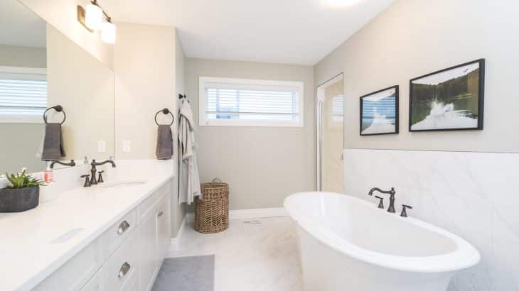 white-bathroom-tub-bathrobe-handing-on-door