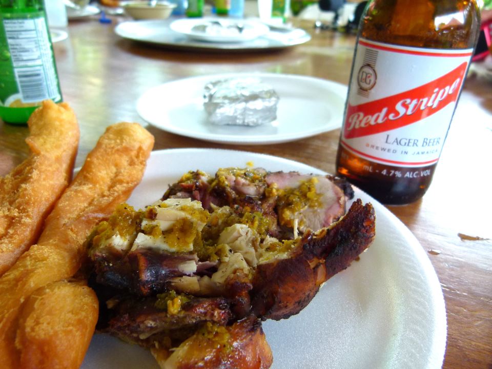 Scotchie's meal with jerk chicken and a Red Stripe.
