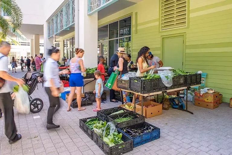 People gather at Farmers & Artisans Market at Camana Bay.