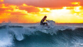 surfer-blue-wave-sunset