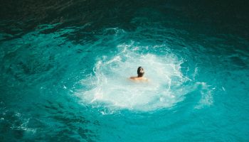 man-swimming-turquoise-water-jamaica
