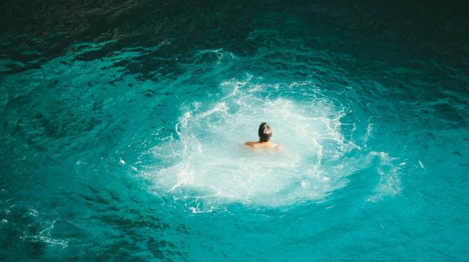 man-swimming-turquoise-water-jamaica