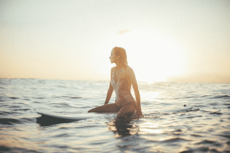 female-surfer-ocean-sunset