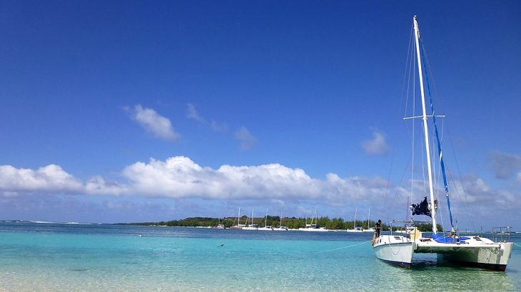 white-catamaran-teal-water