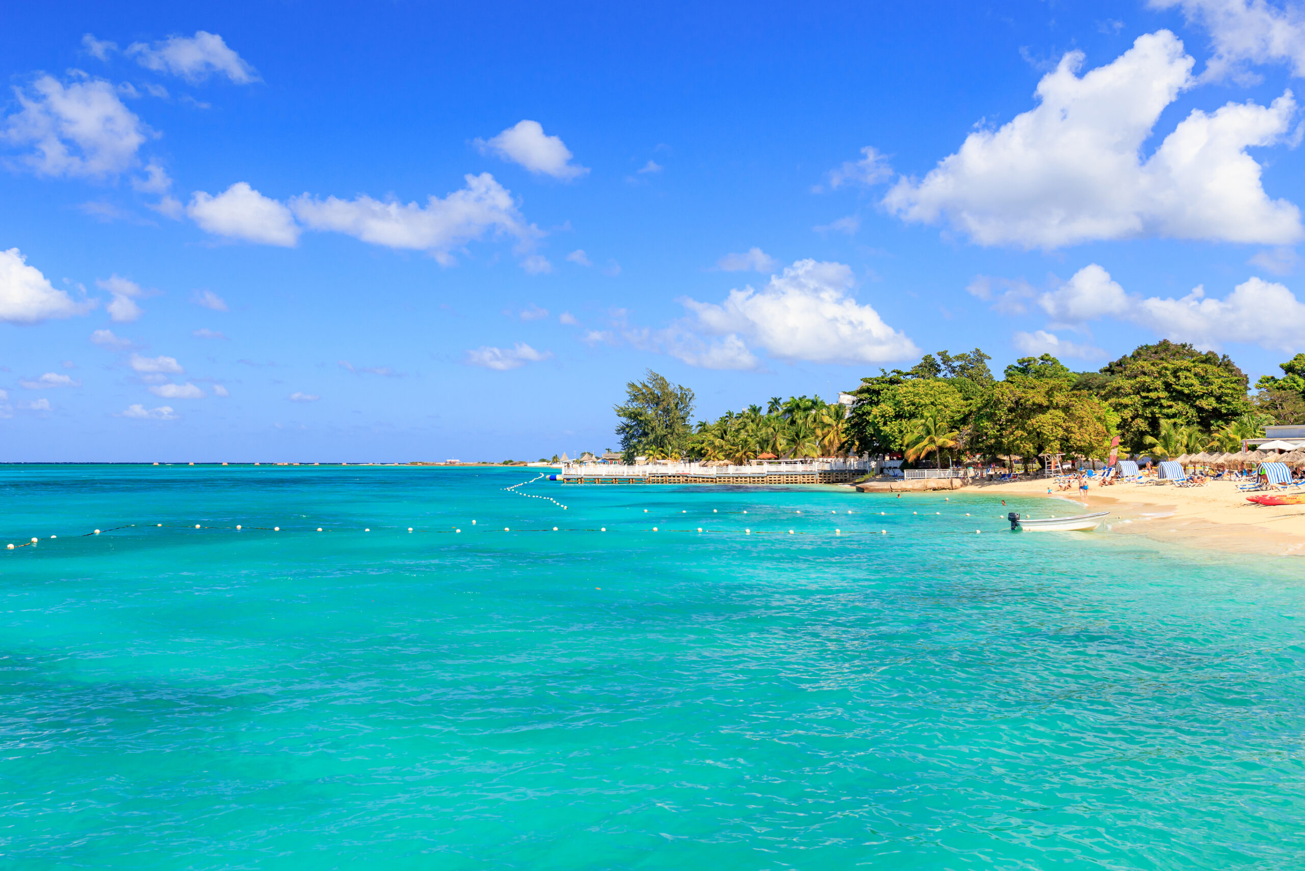 Beach with turquoise water at Doctor`s cave in Montego Bay Jamaica.