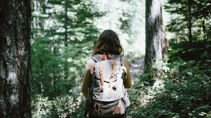 girl-backpack-hiking-forest