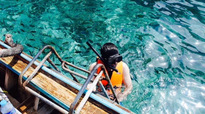 person-snorkeling-turquoise-water