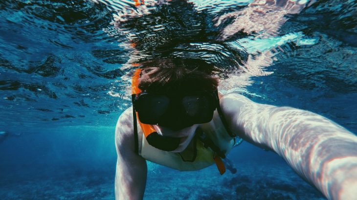 boy-snorkeling-blue-water