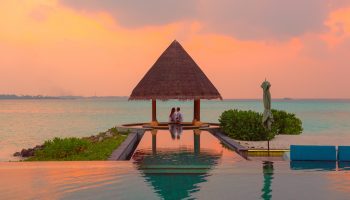 couple-sunset-beach-hut-ocean