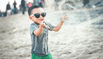 child-playing-sand-beach