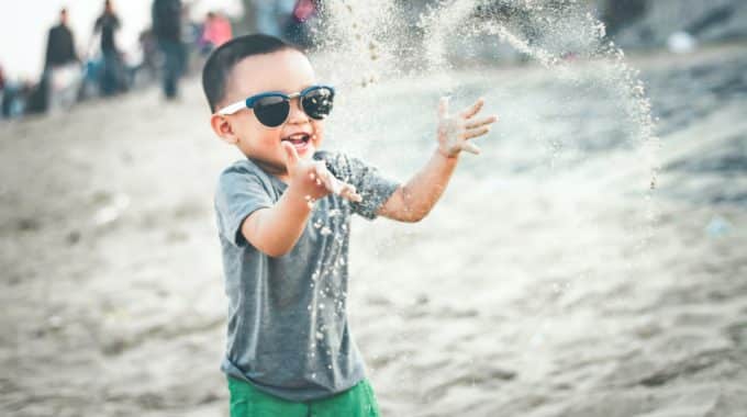 child-playing-sand-beach