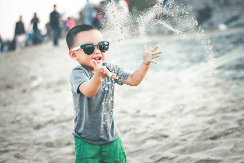 child-playing-sand-beach