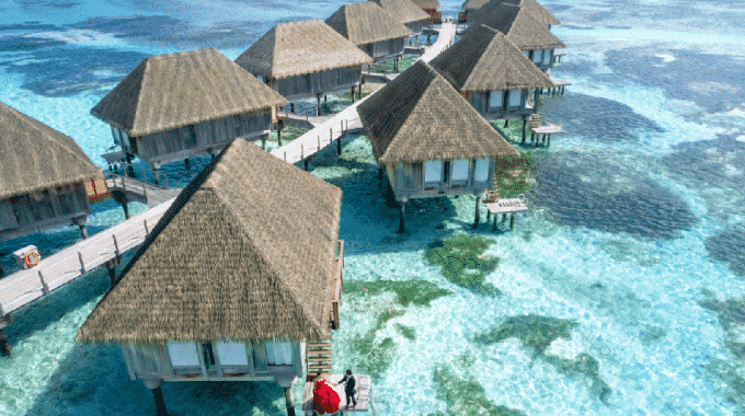 overwater-bungalow-turquoise-water-couple