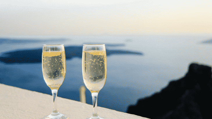 champagne-glasses-balcony-over-water