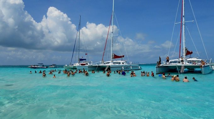 turquoise-water-anchored-boats-people-swimming