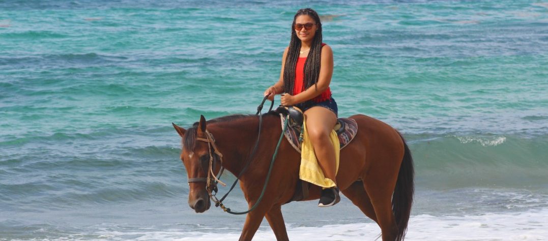 woman-riding-brown-horse-on-beach-puerto-rico