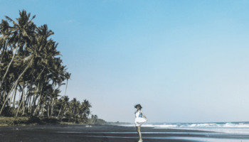 girl-walking-away-black-sand-beach