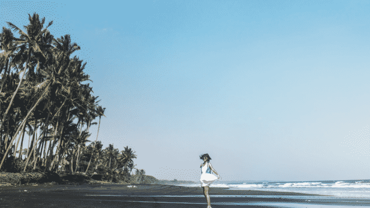 girl-walking-away-black-sand-beach