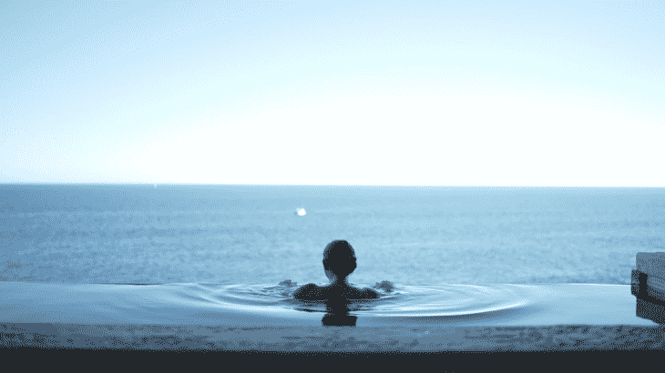 woman-overlooking-view-infinity-pool