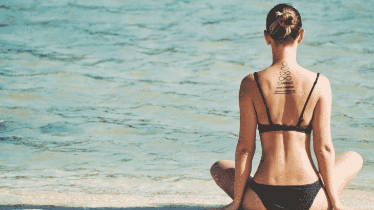 woman-meditating-beach