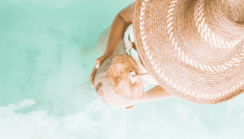 woman-holding-coconut-view-from-top-her-hat