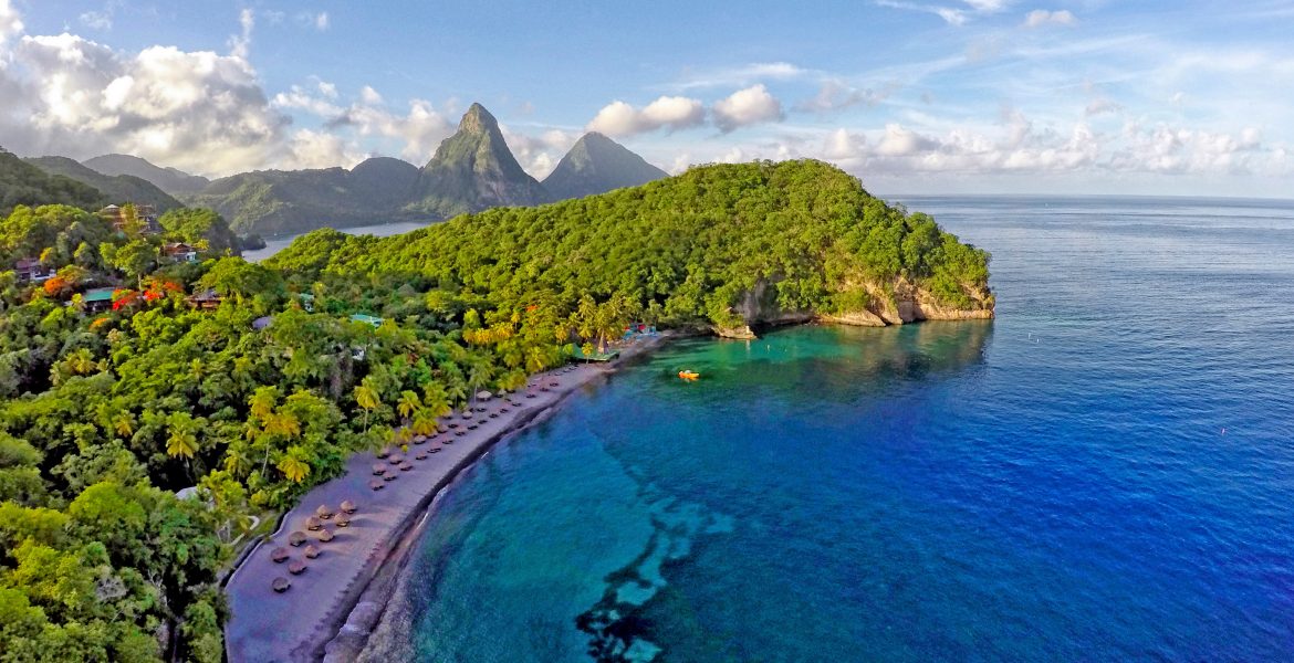 cresent-shaped-cove-from-above-blue-water-green-jungle