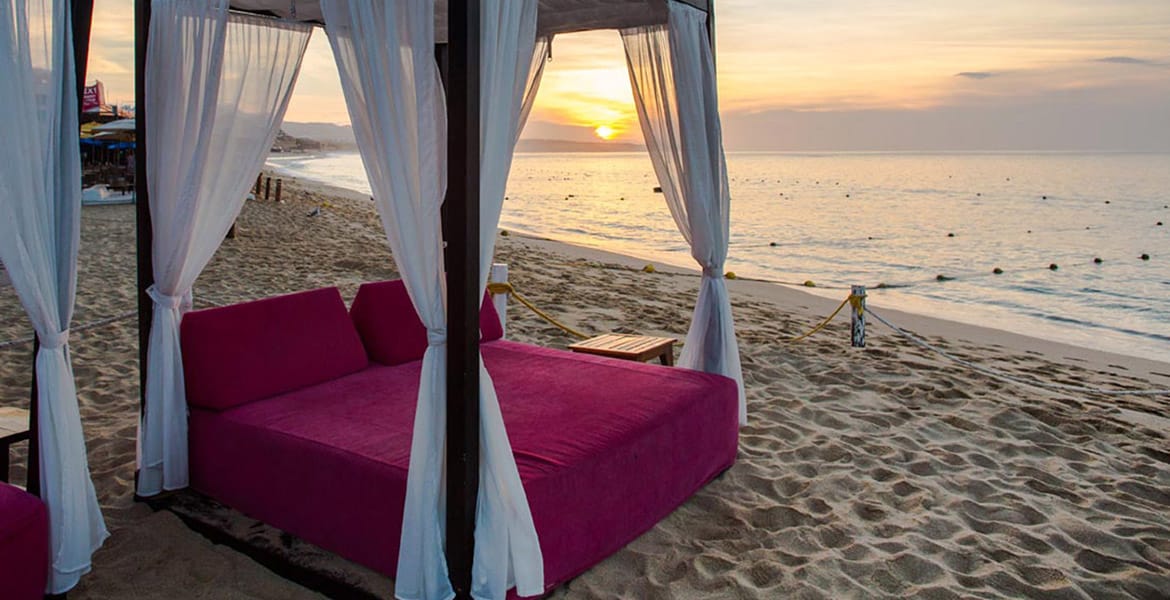 hot-pink-bali-bed-on-beach-at-sunset