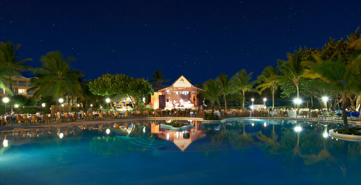 resort-pool-lit-up-buildings-sunset