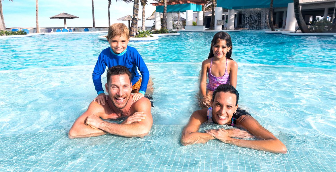 parents-children-in-pool-on-shoulders