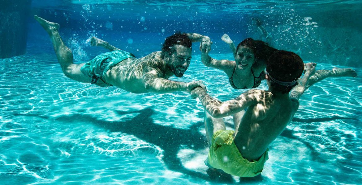 family-swimming-underwater-pool