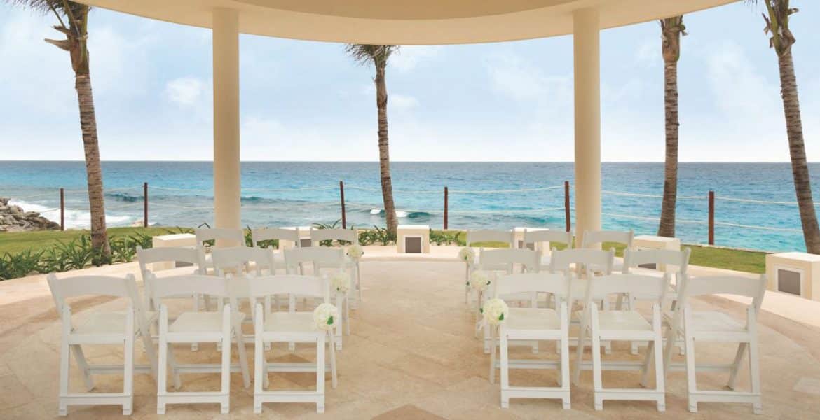 beach-wedding-setup-white-chairs-white-sand-ocean-view