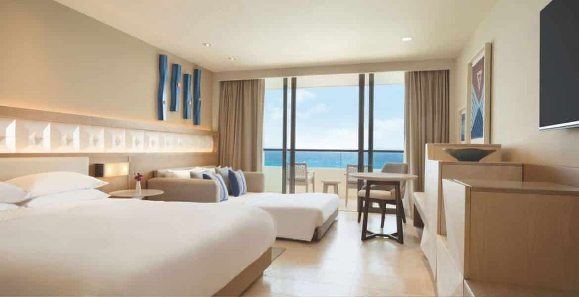 hotel-suite-two-white-beds-ocean-view-balcony