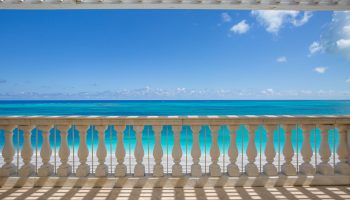 luxury-suite-balcony-turquoise-ocean-view-blue-sky