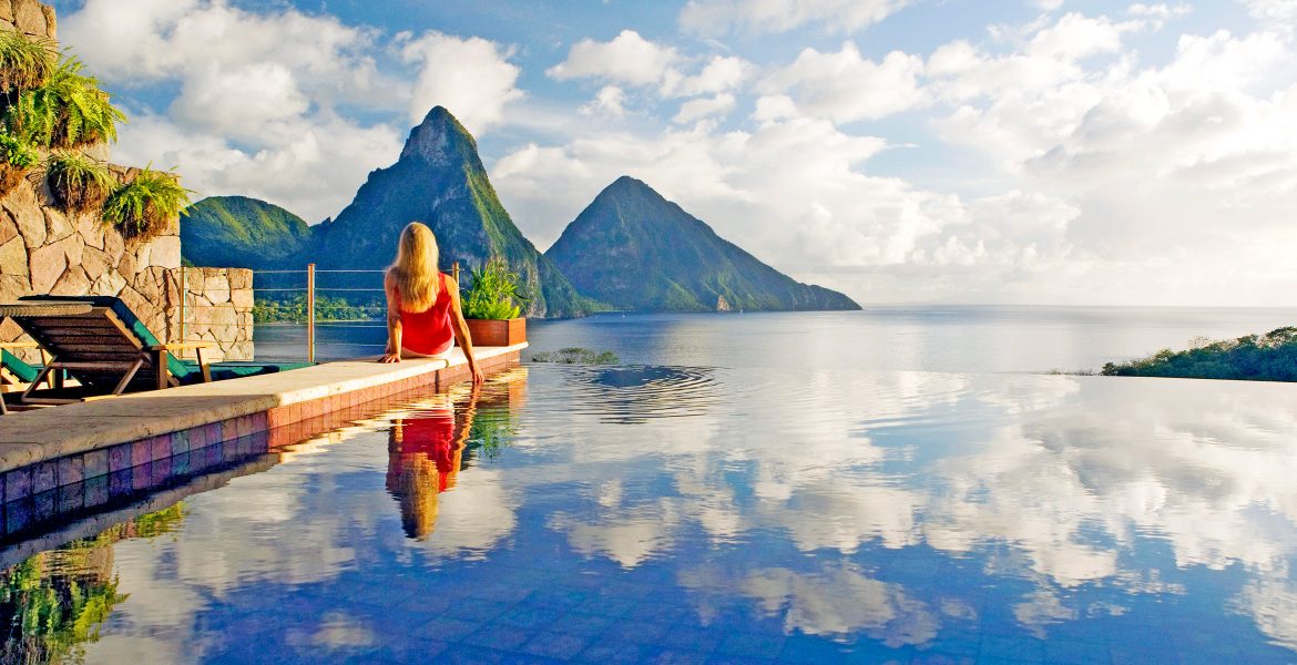 woman-sitting-edge-pool-looking-pitons-peaks