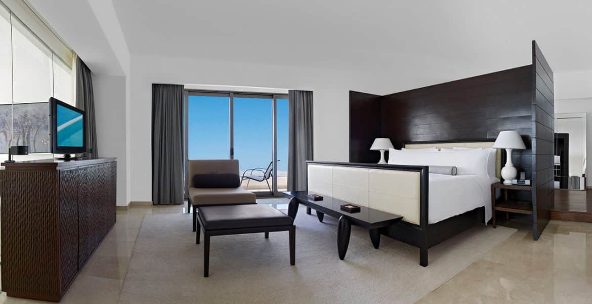 luxury-hotel-room-bed-table-ocean-view