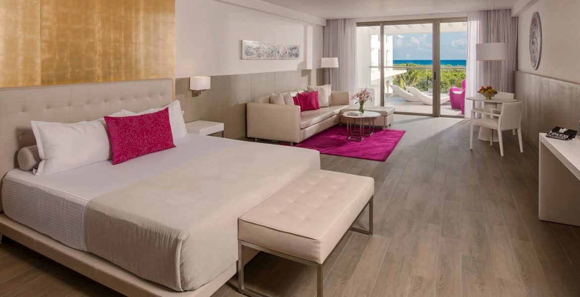 luxurious-resort-suite-plush-beds-pink-accents