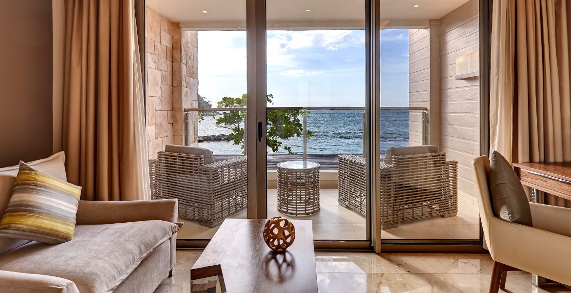 luxury-suite-glass-door-balcony-overlooking-ocean