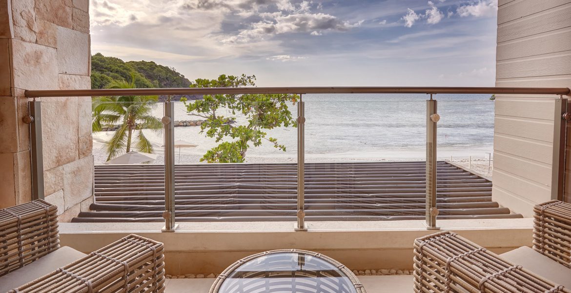 balcony-overlooking-blue-ocean-sky-green-plant