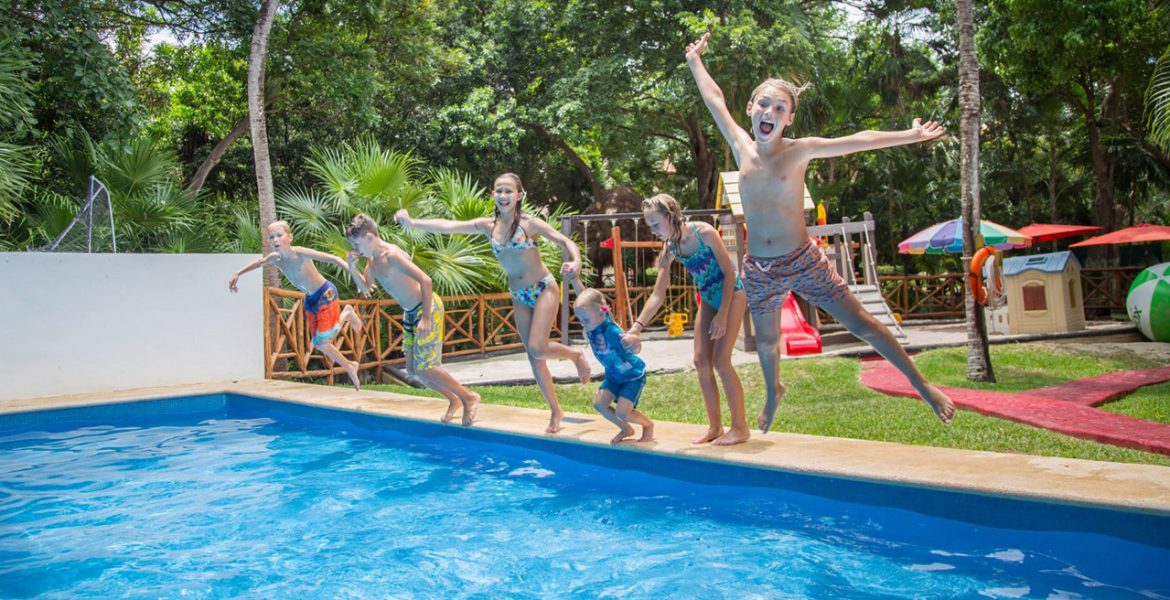 children-jumping-into-pool