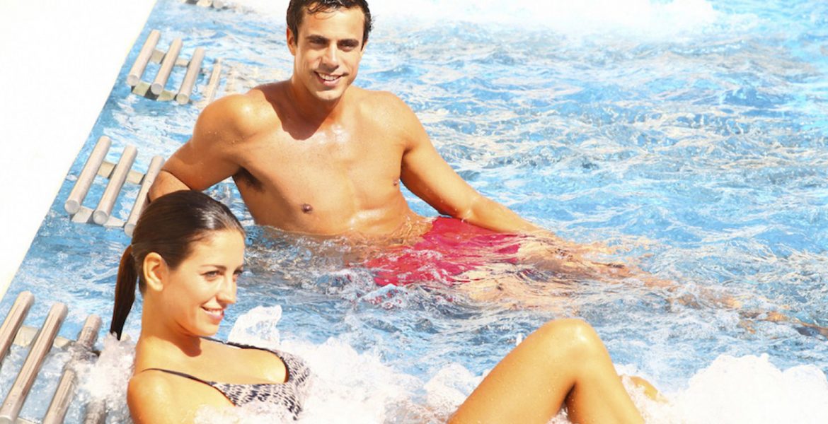 couple-sitting-in-clear-water-pool