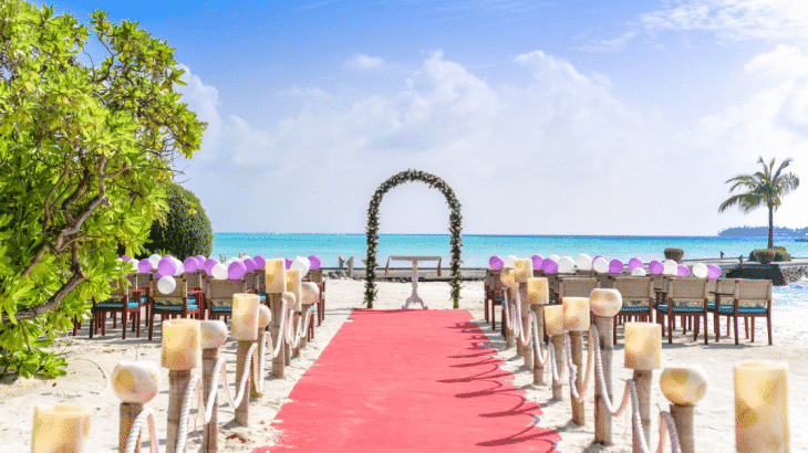 beach-wedding-setup-pink-walkway-arch-chairs