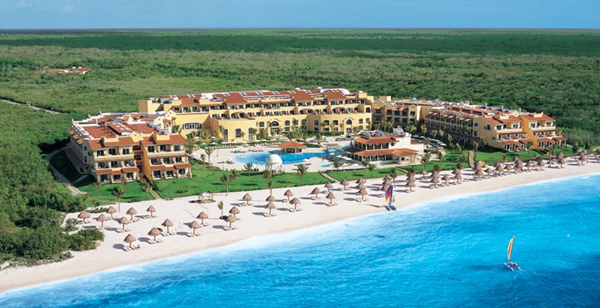 aerial-view-beach-resort-yellow-building-blue-ocean