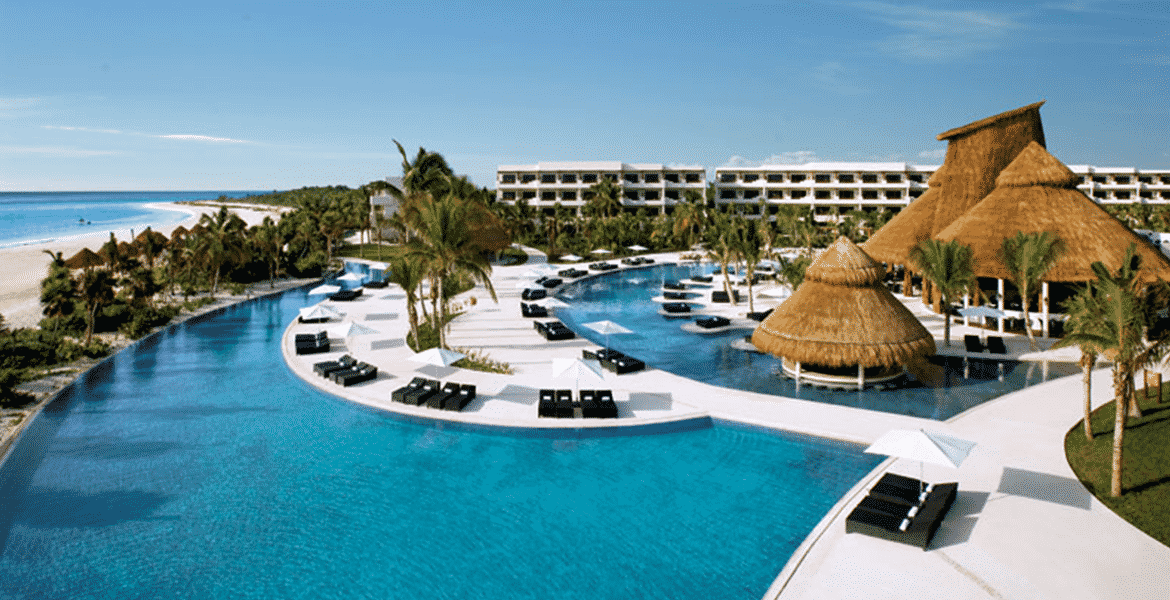 beach-resort-pool-loungers-palm-trees