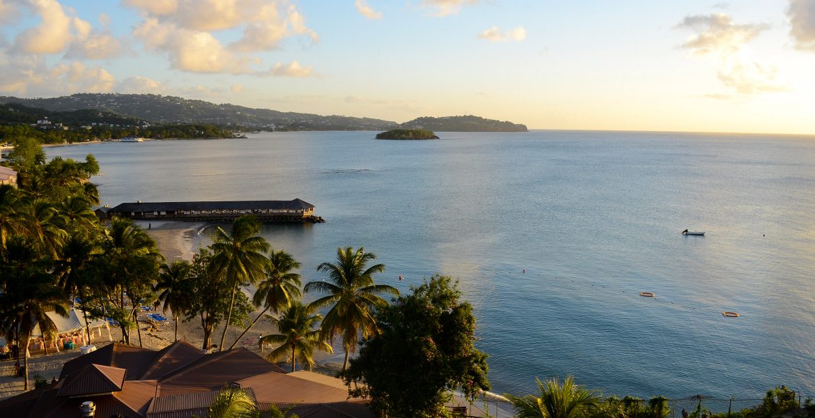 view-overlooking-blue-bay-with-palm-trees