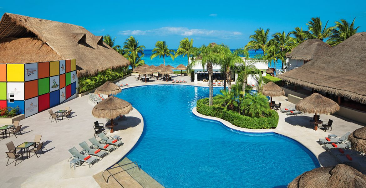 resort-pool-with-buildings-palm-trees