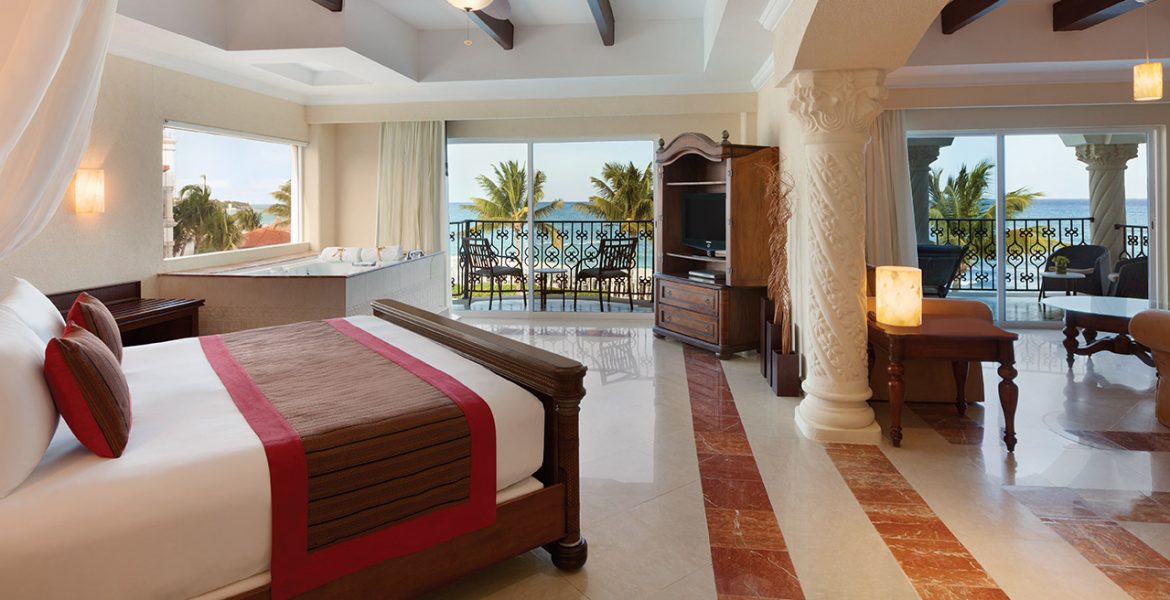 resort-suite-open-doors-dark-wood-bed