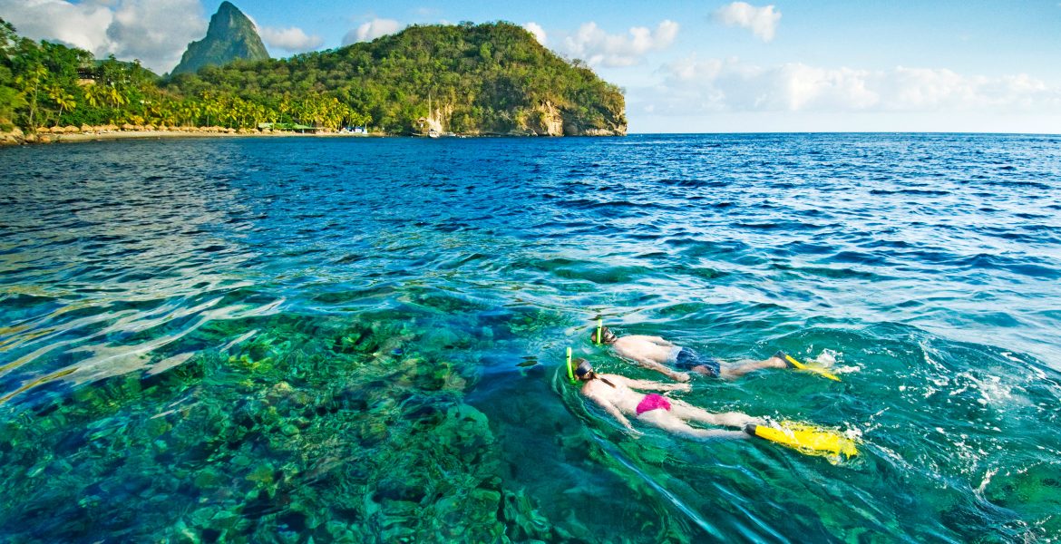 turquoise-water-pitons-peaks-man-woman-snorkeling