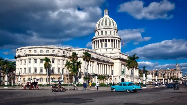 white-building-blue-classic-car-havana-cuba