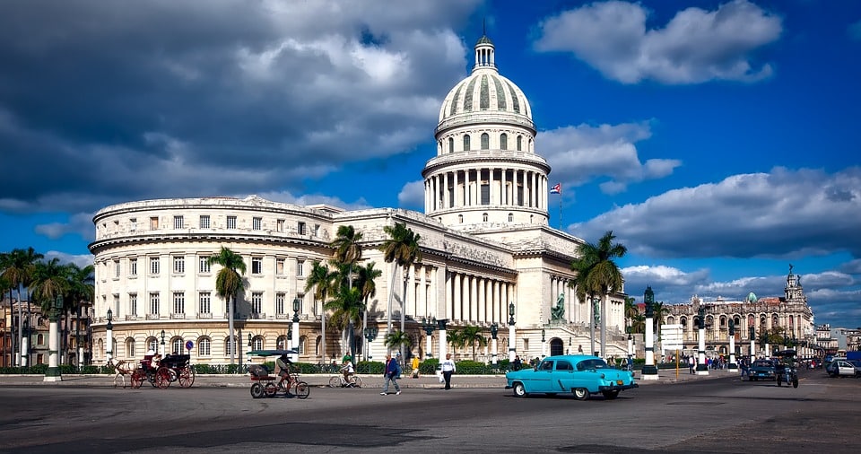 white-building-blue-classic-car-havana-cuba